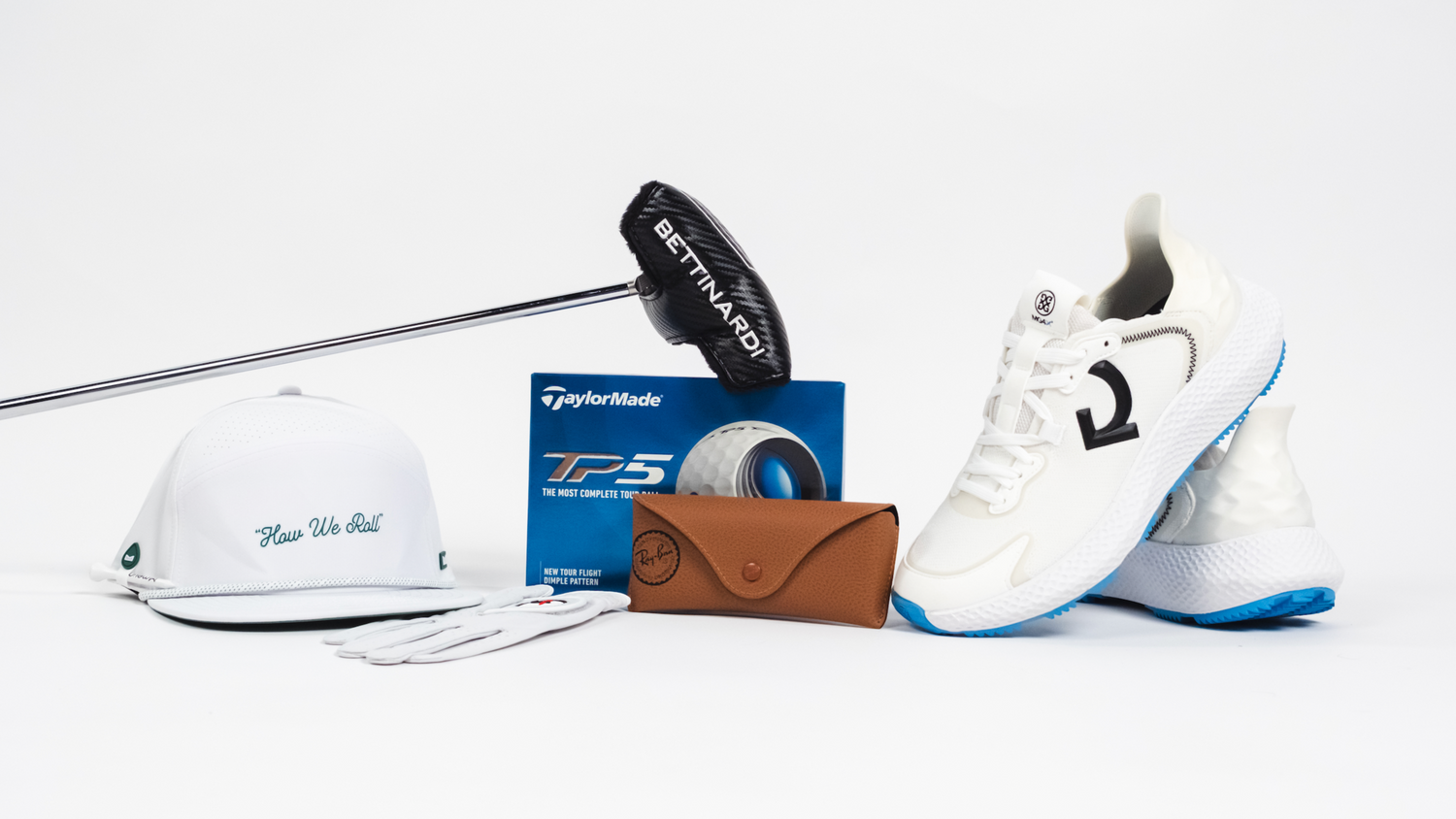 Golf equipment including a club, hat, shoes, and a wallet on a white background